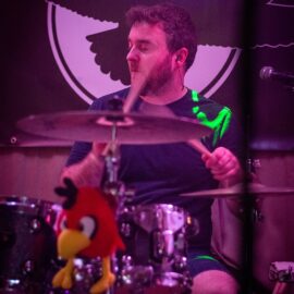 Edd pounding the drums in rock band Solarbird